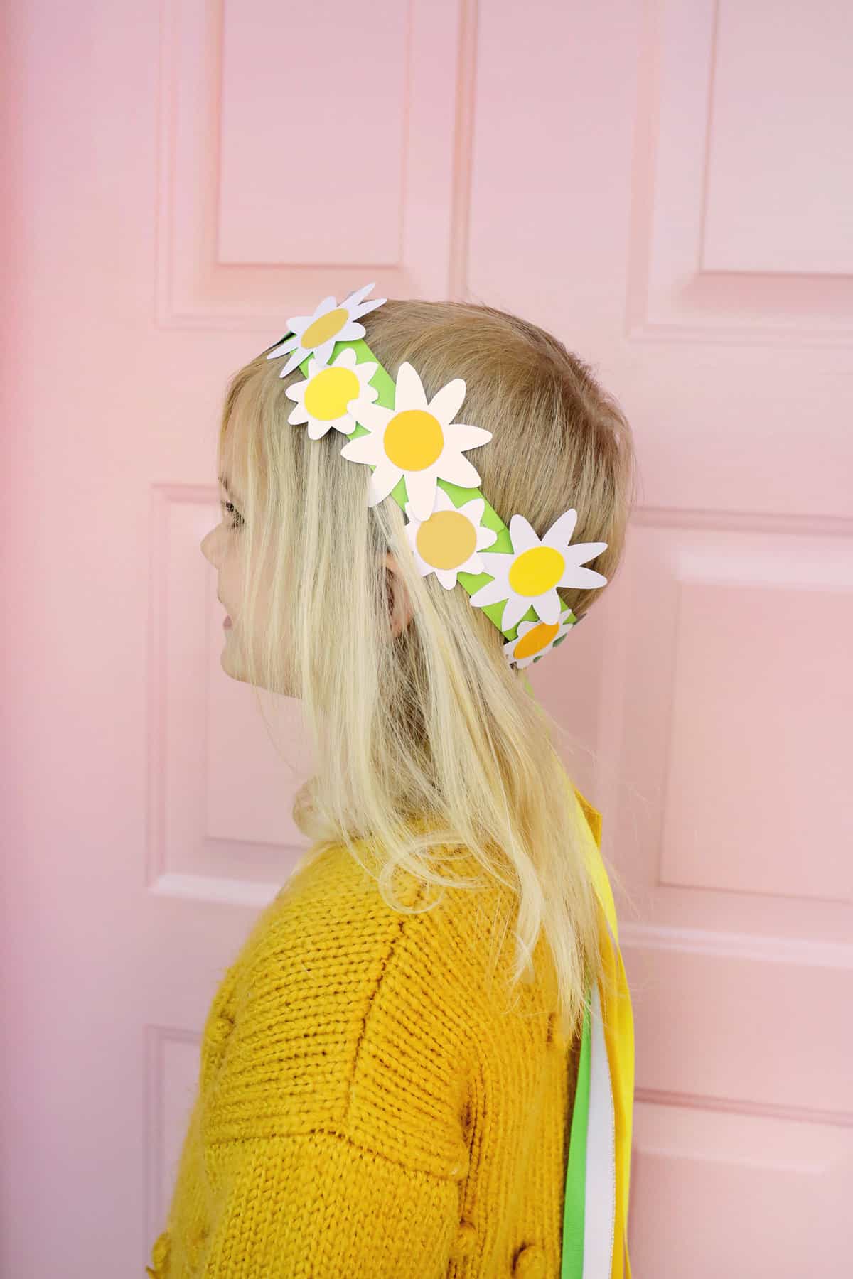 girl wearing paper daisy crown