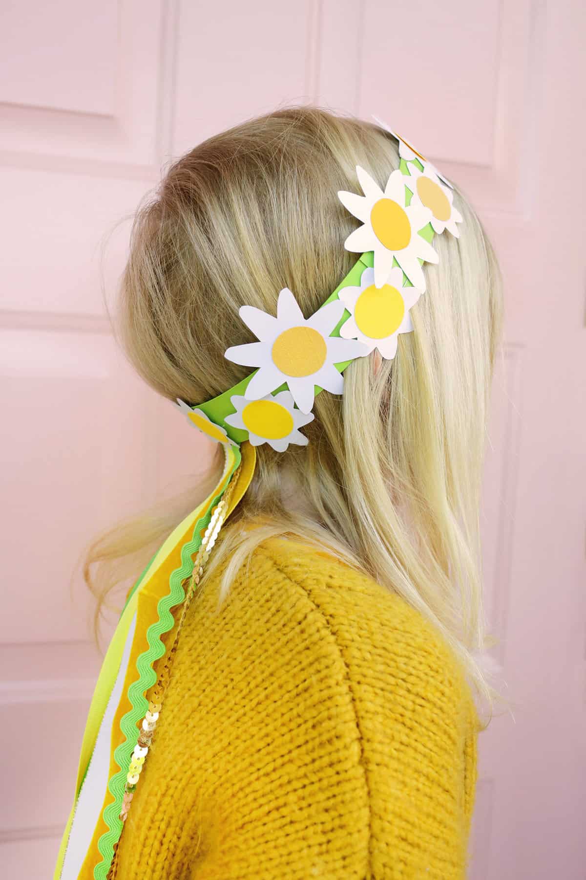 girl wearing paper daisy crown