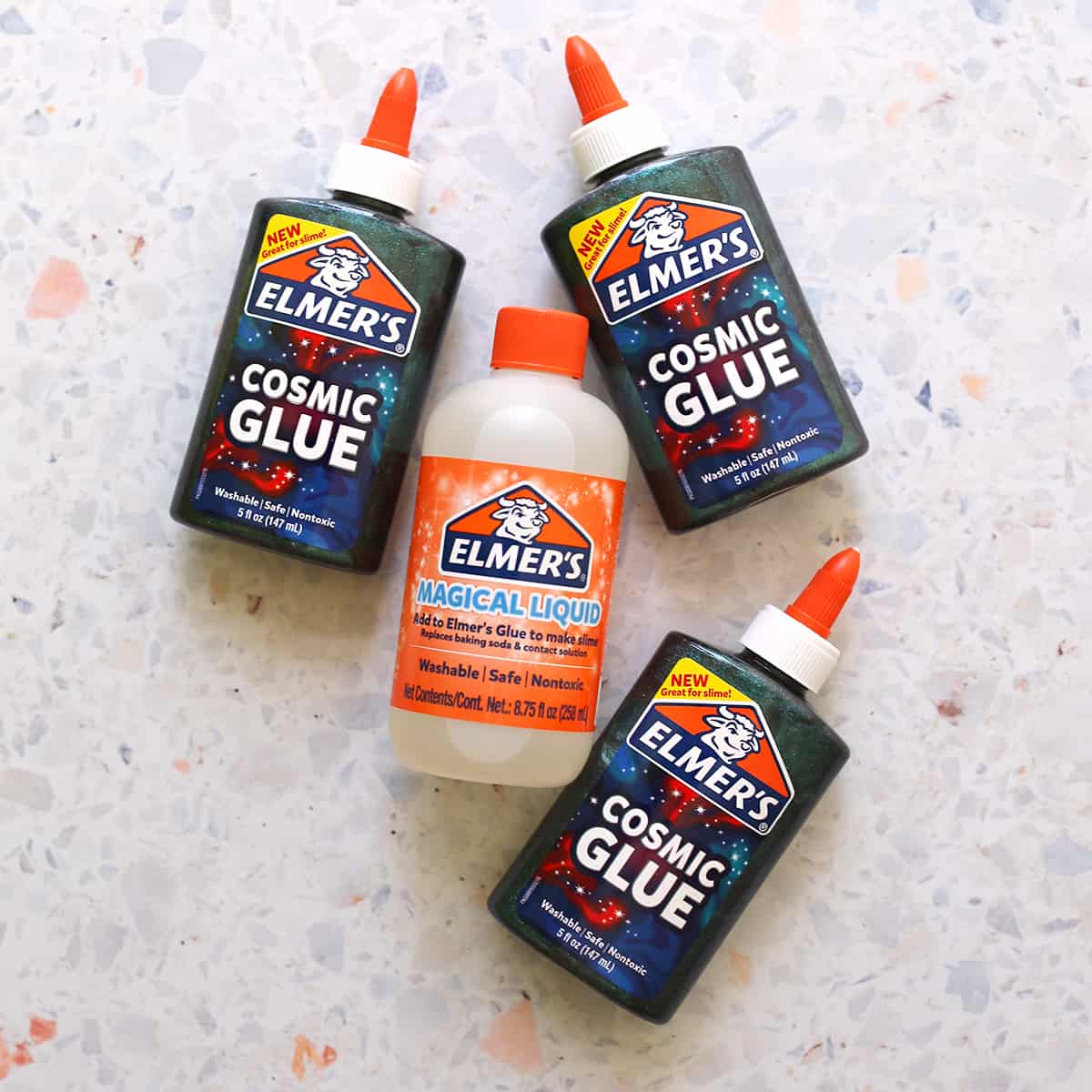 cosmic glue and Elmer's magical liquid sitting on counter. 