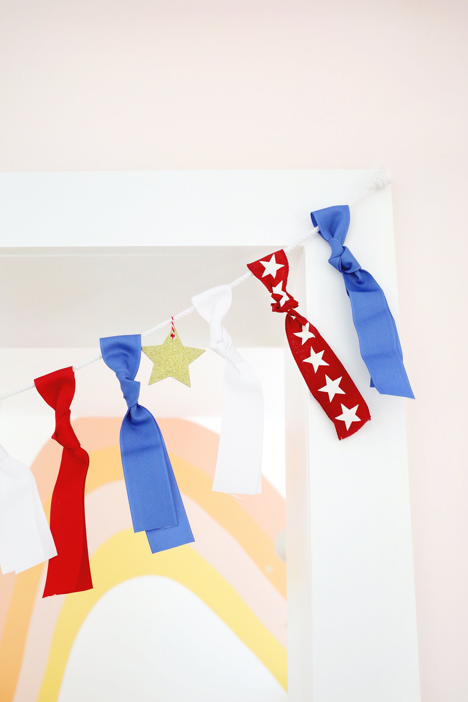 ribbon garland hanging over artwork for the 4th of July. 