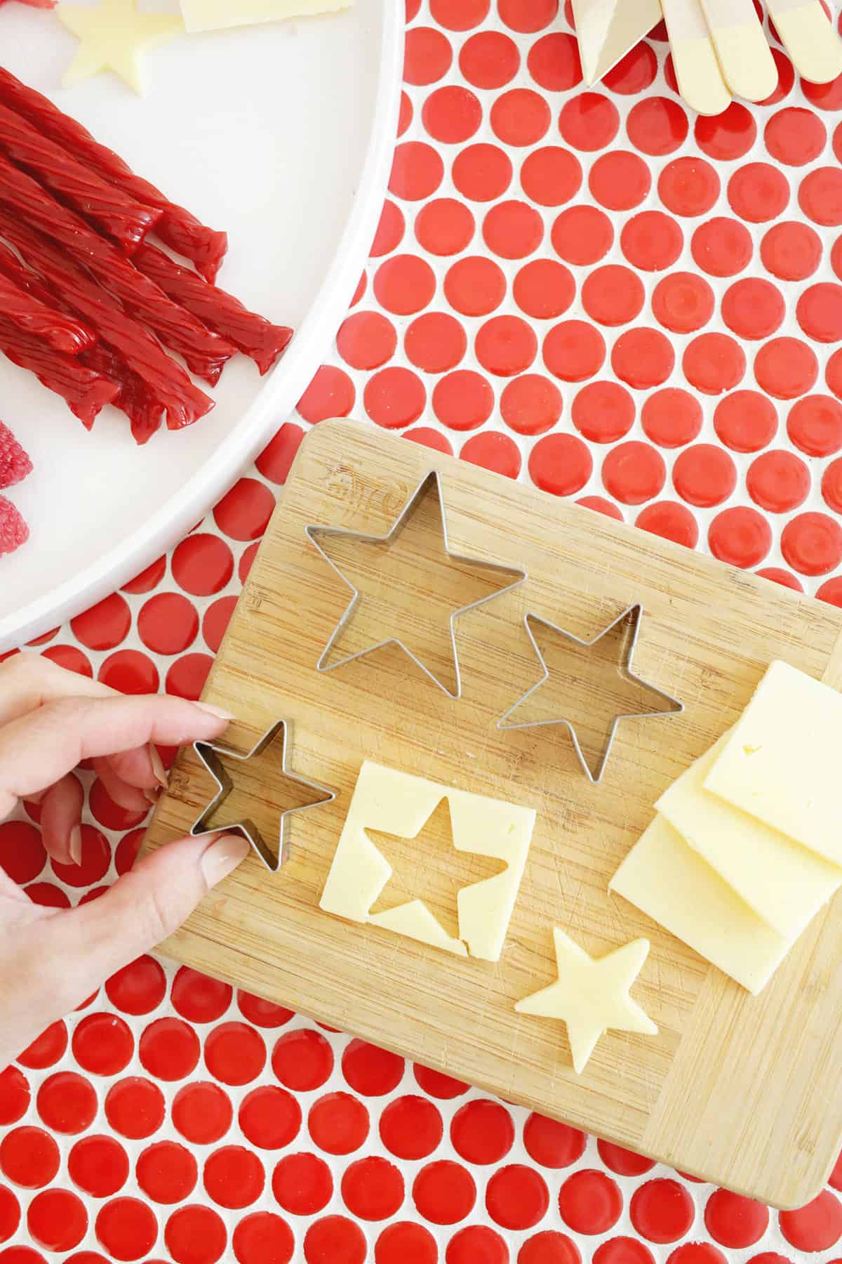 cutting cheese into star shapes with a cookie cutter