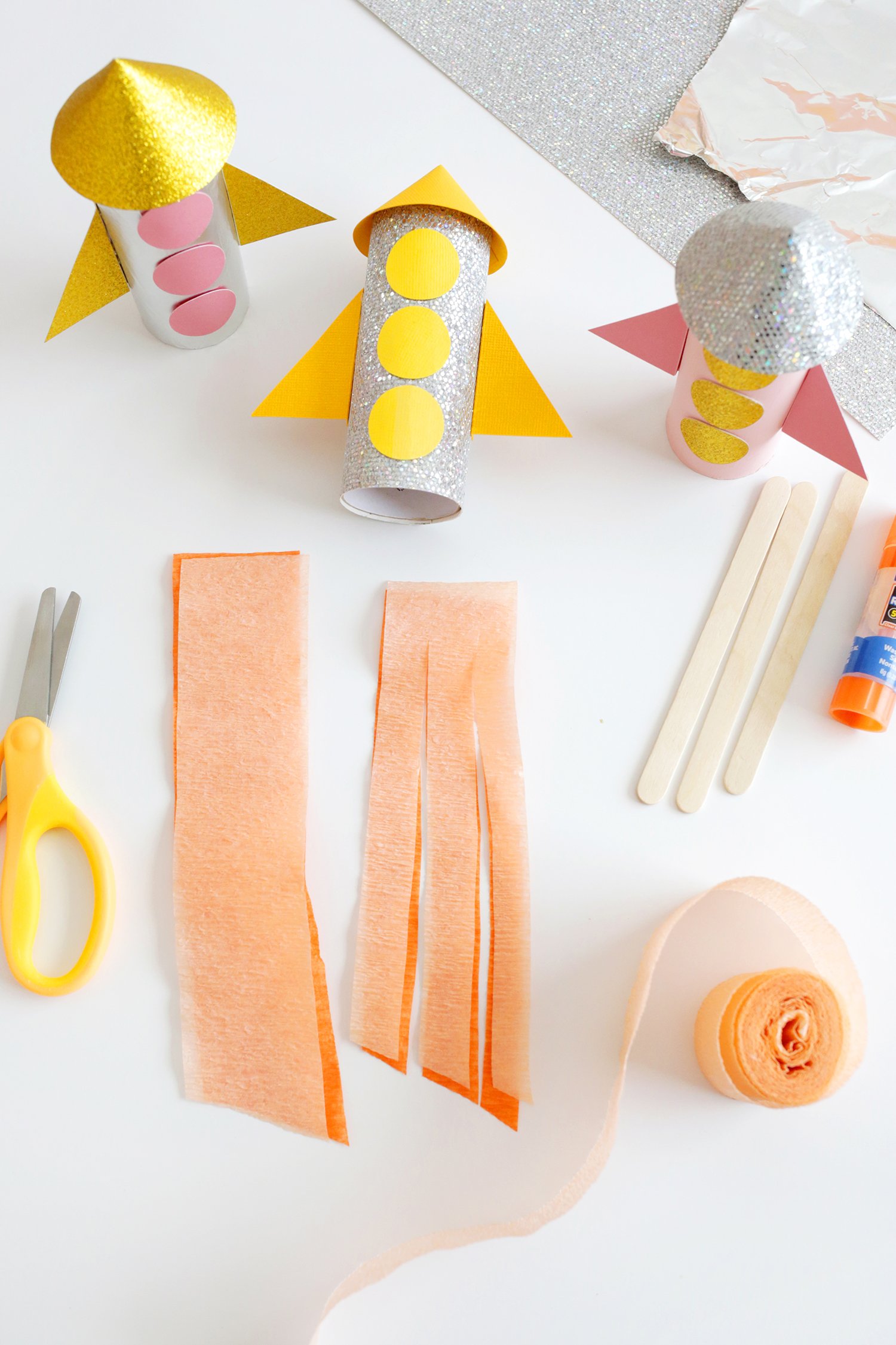 paper rocket ships with crepe paper flames being cut