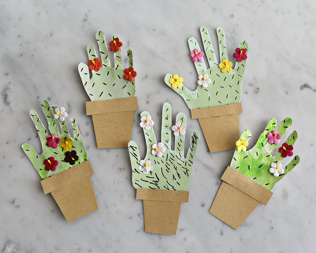 Paper cactus craft made with handprints. 