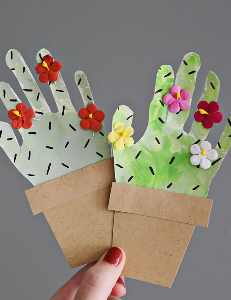 handprint cactus paper craft being held.