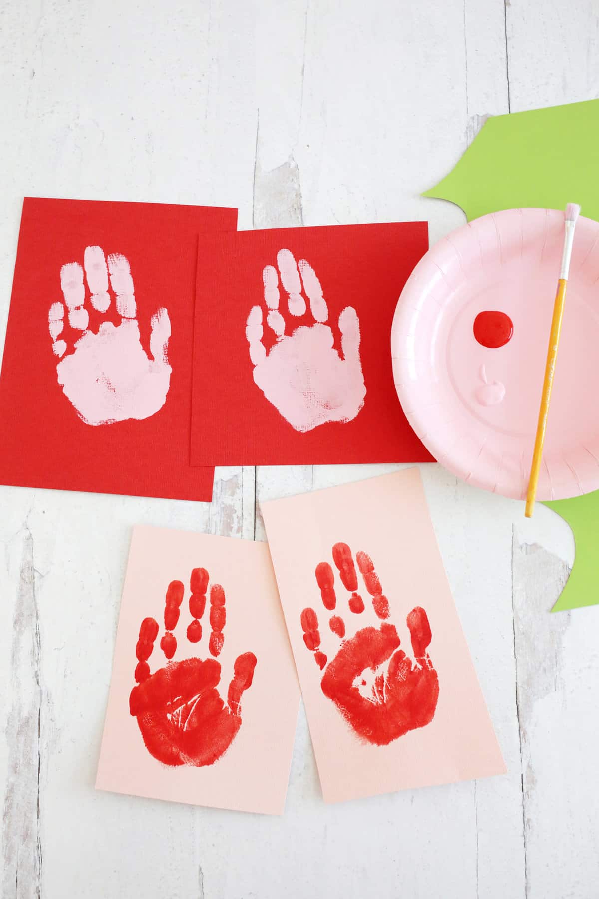 kids hand stamps on paper using paint