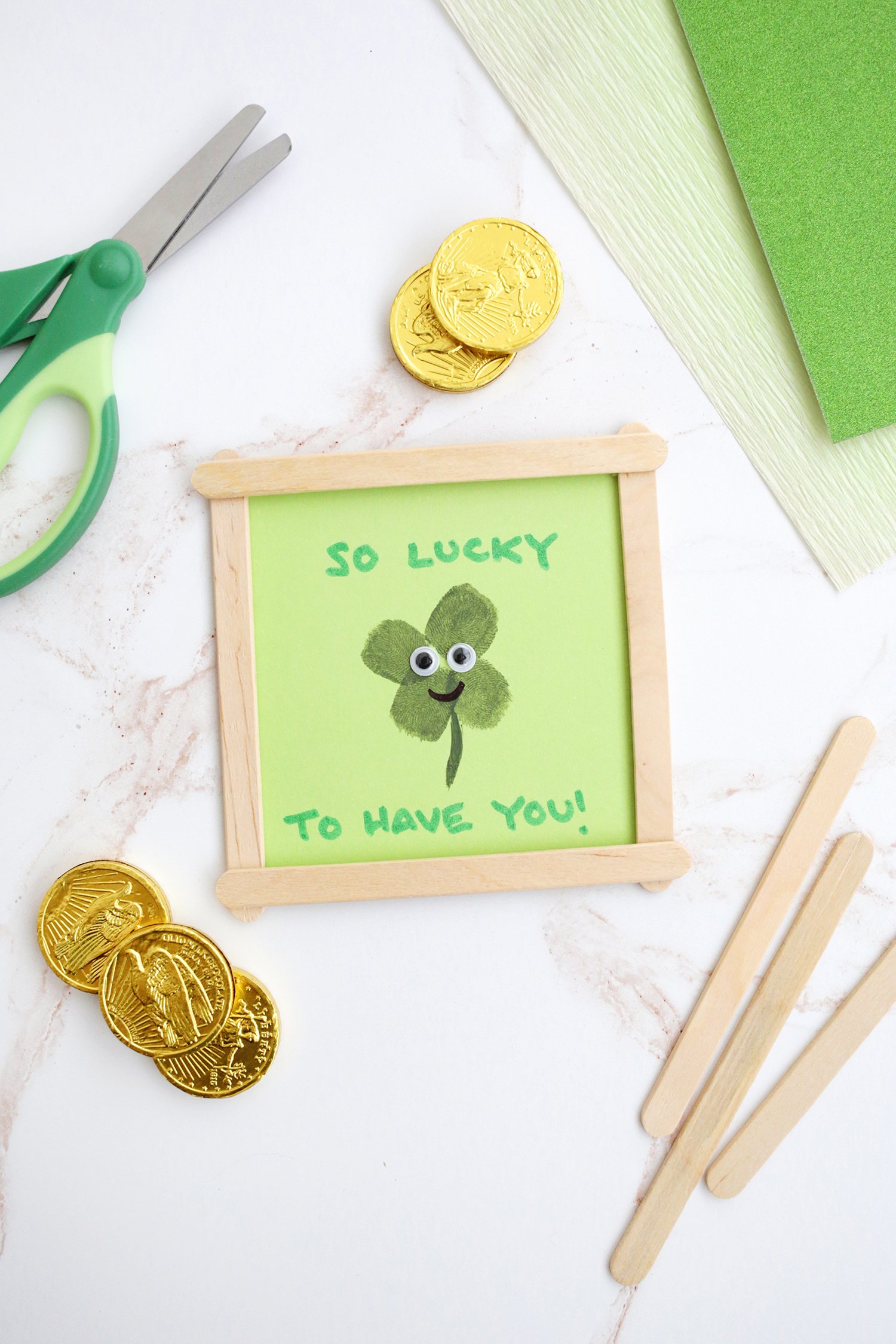 Four leaf clover fingerprint craft that says "so lucky to have you"