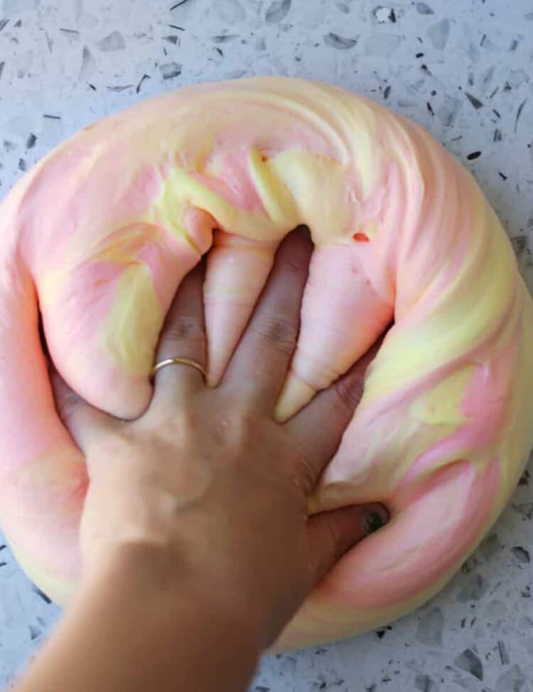 fluffy slime being pressed with a hand