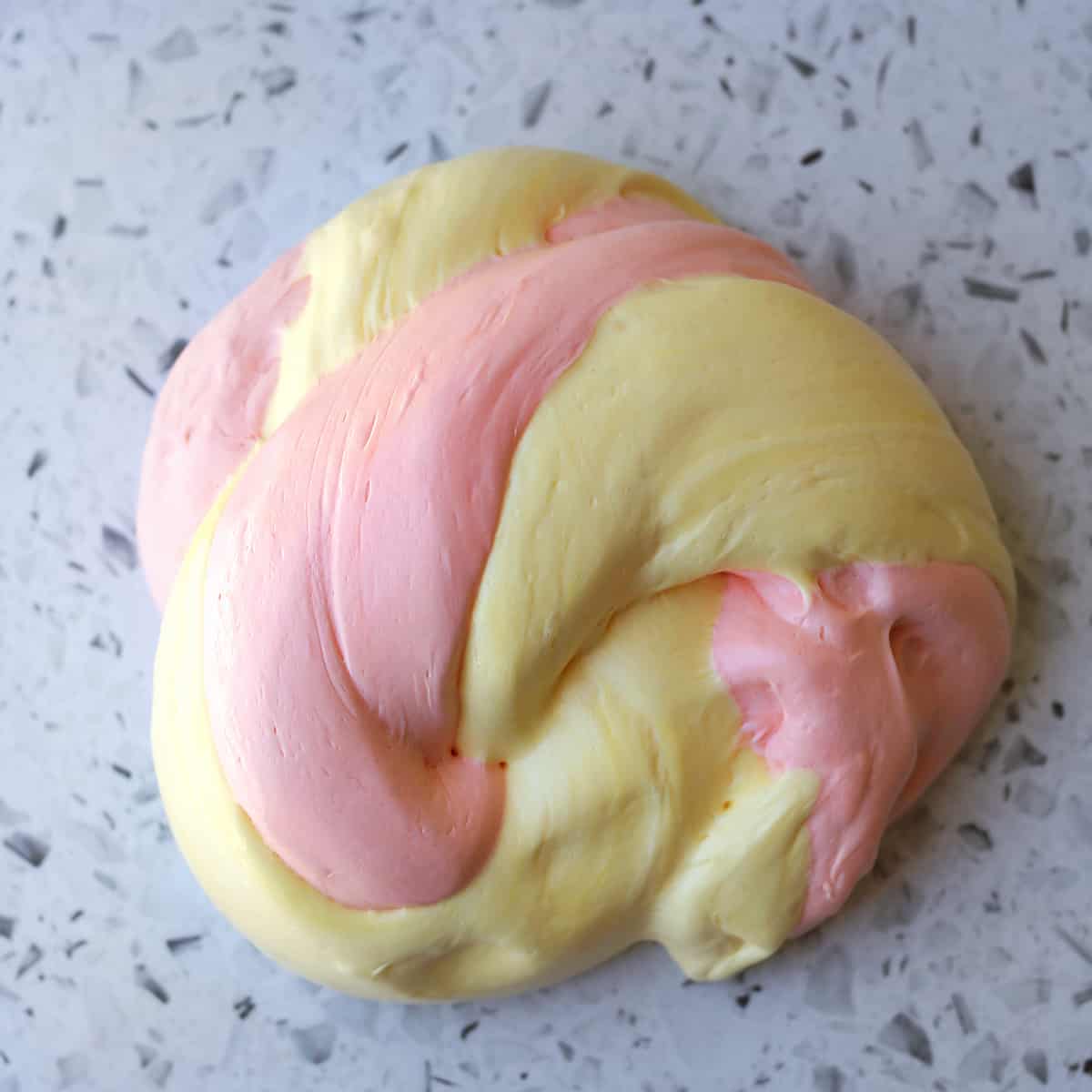 pink and yellow fluffly slime on counter. 