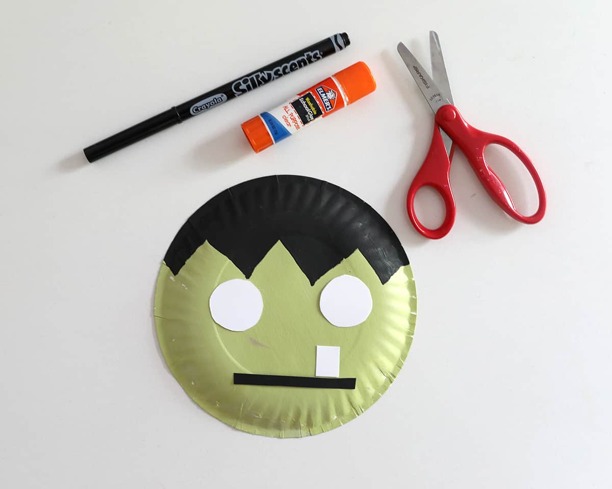 scissors, gluestick, marker and paper plate painted green to look like frankenstein. 