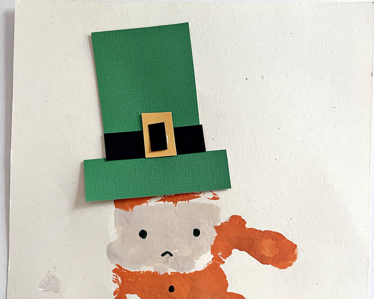 Handprint leprechaun craft with construction paper hat. 