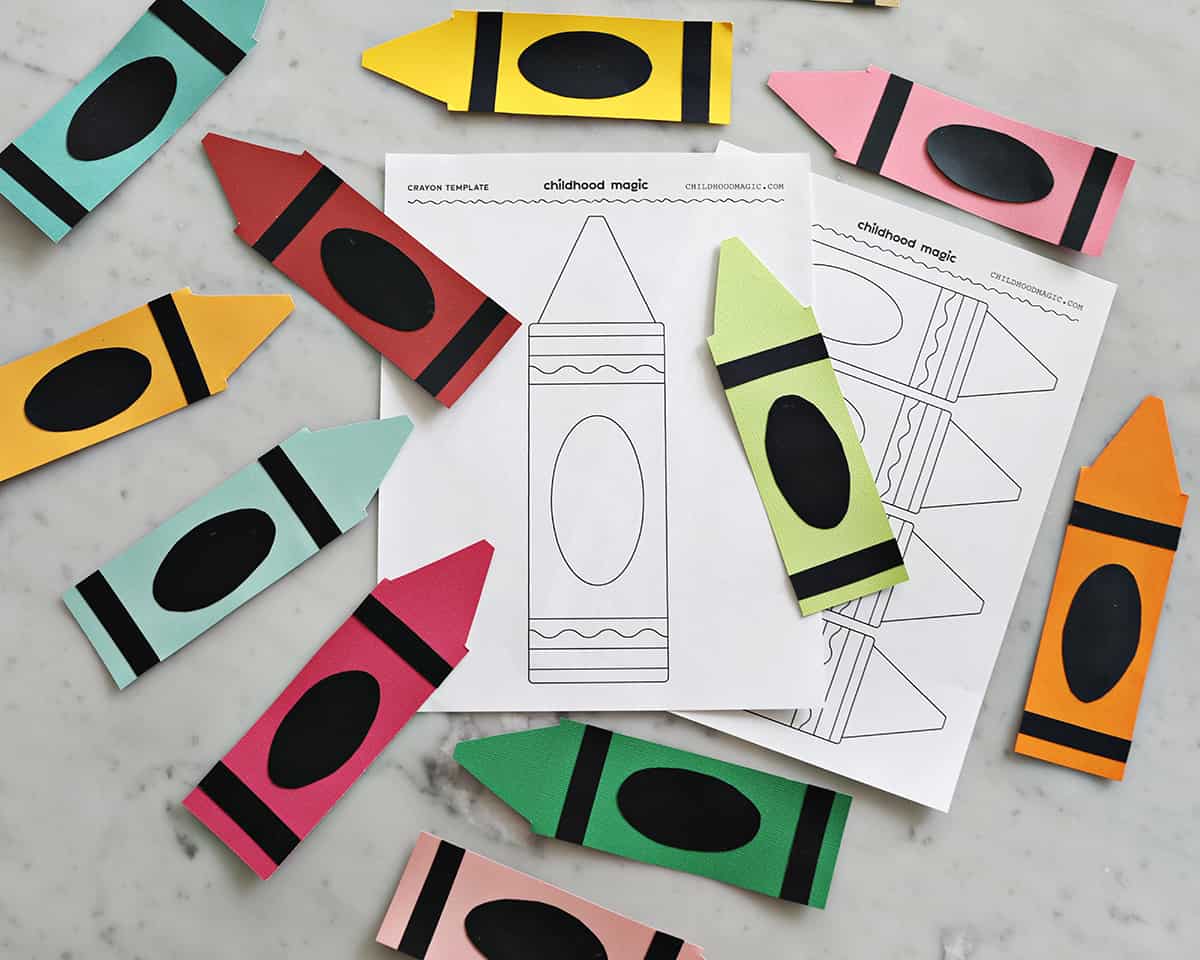 various colors of construction paper cut out into shapes of crayons and crayon template.