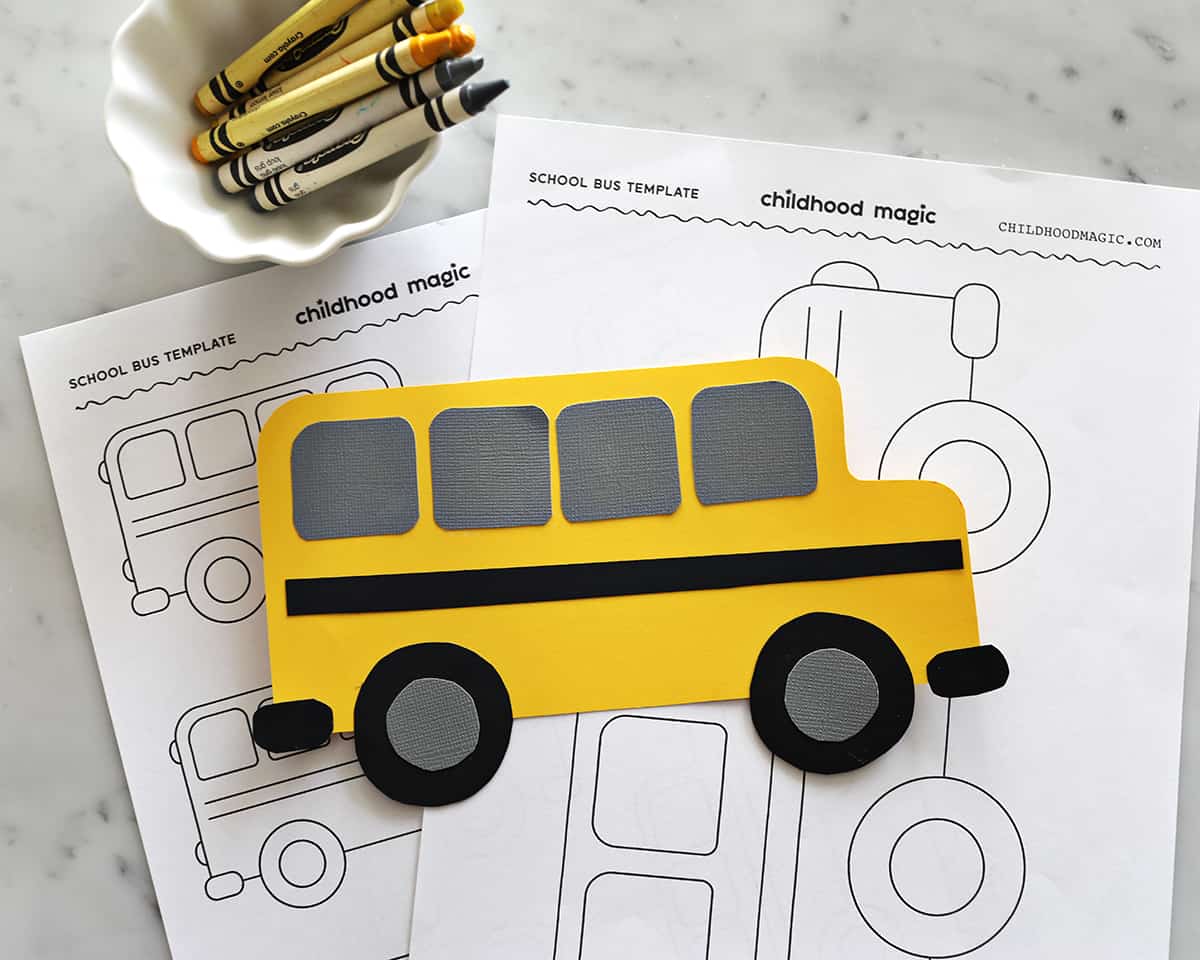 School bus cutout with yellow, gray and black construction paper on counter.