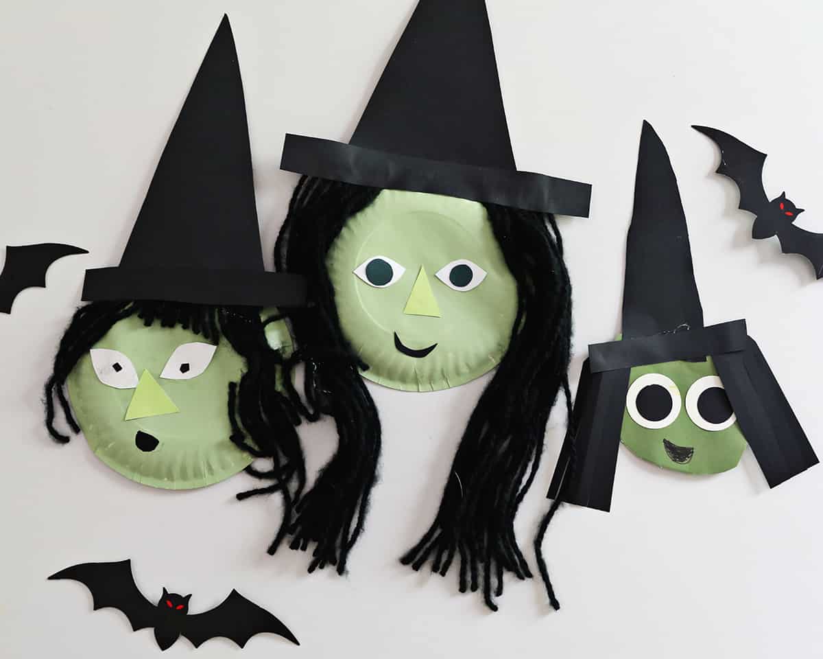 paper plates painted green and decorated to look like witches. 