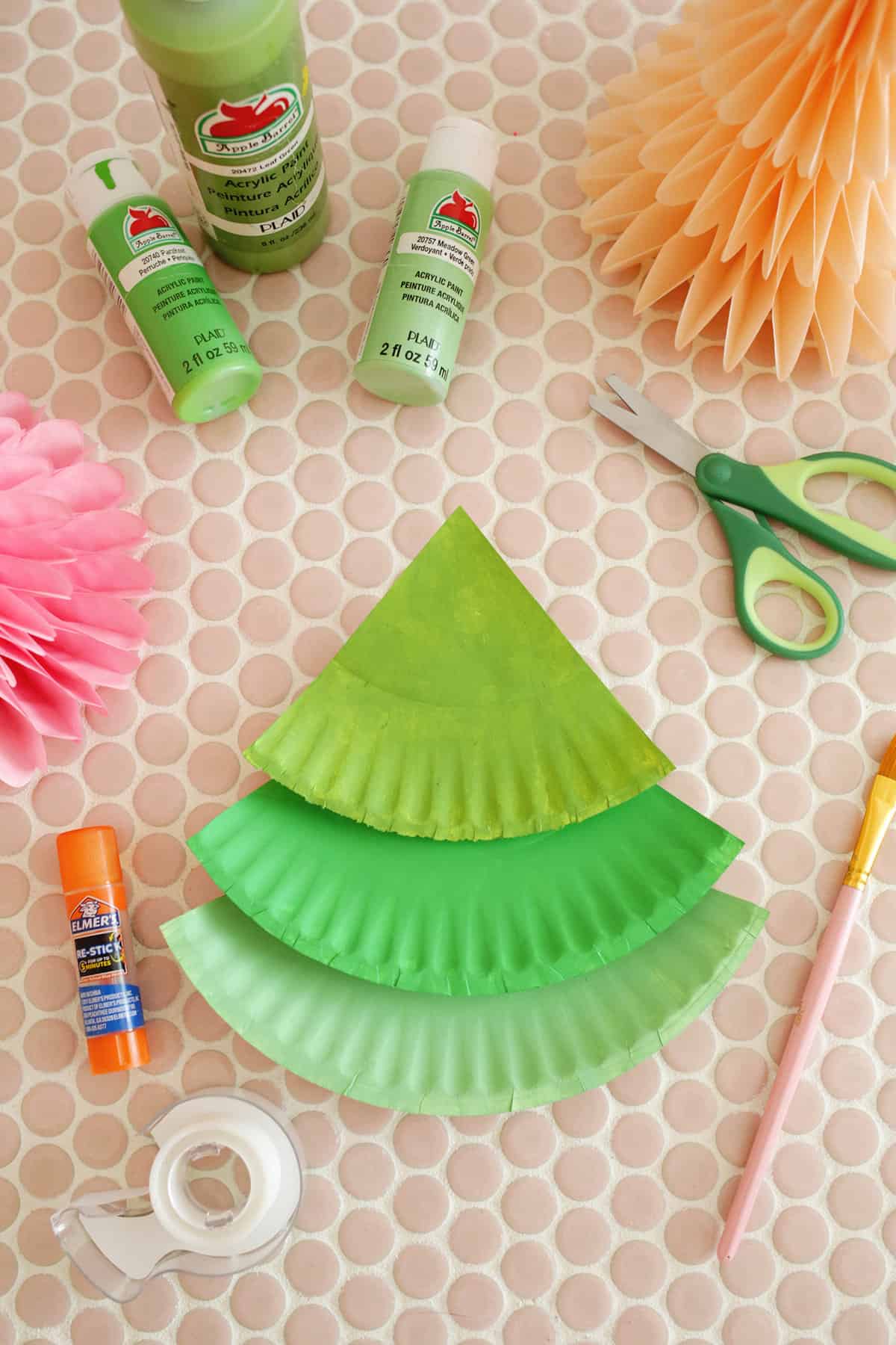 three sections of green paper plate stacked into a christmas tree shape