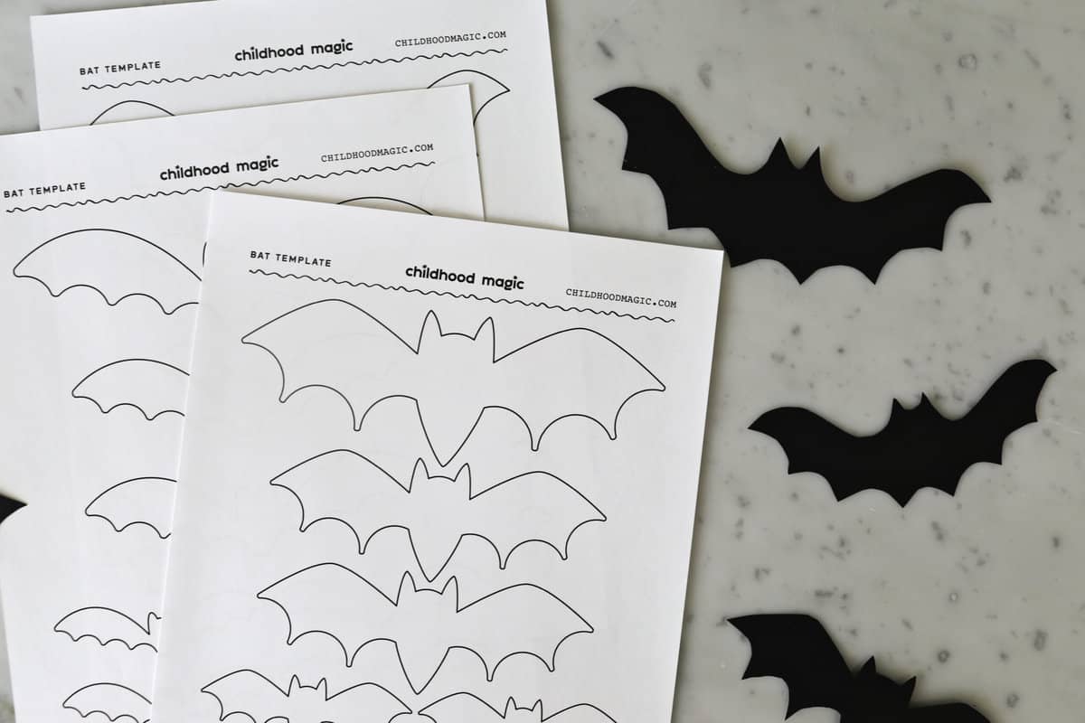 paper with bat outlines and cutouts of bats on counter. 