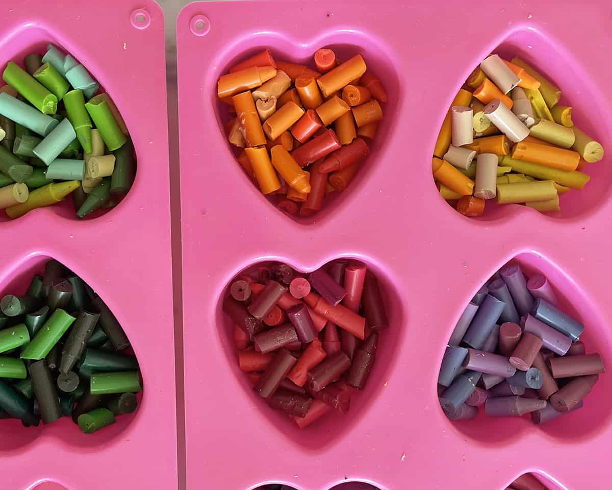 Broken pieces of crayons in heart-shaped molds.