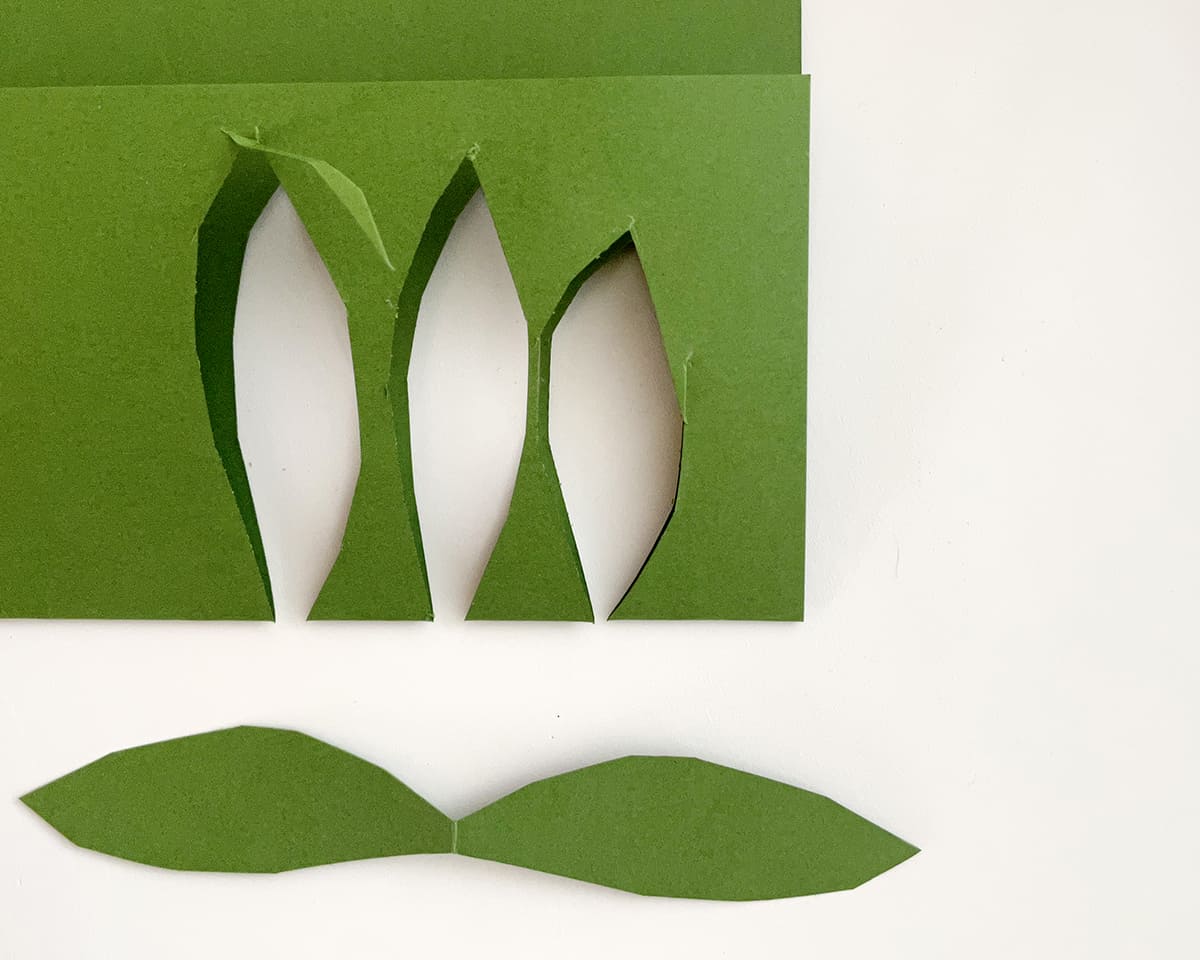 green paper leaves that have been cut from construction paper.
