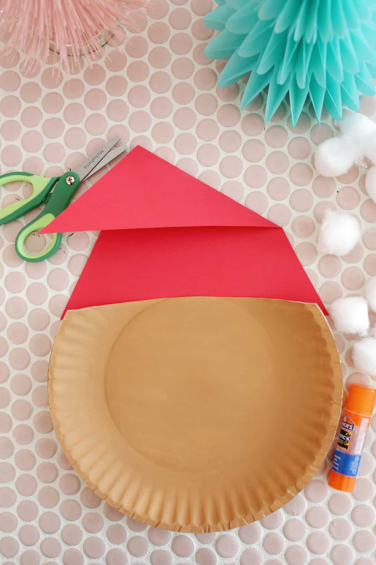 making a red triangle hat for a paper plate santa