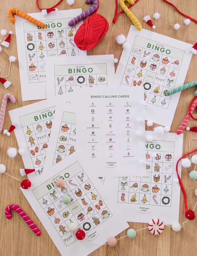 Printable Christmas themed bingo cards on the floor.