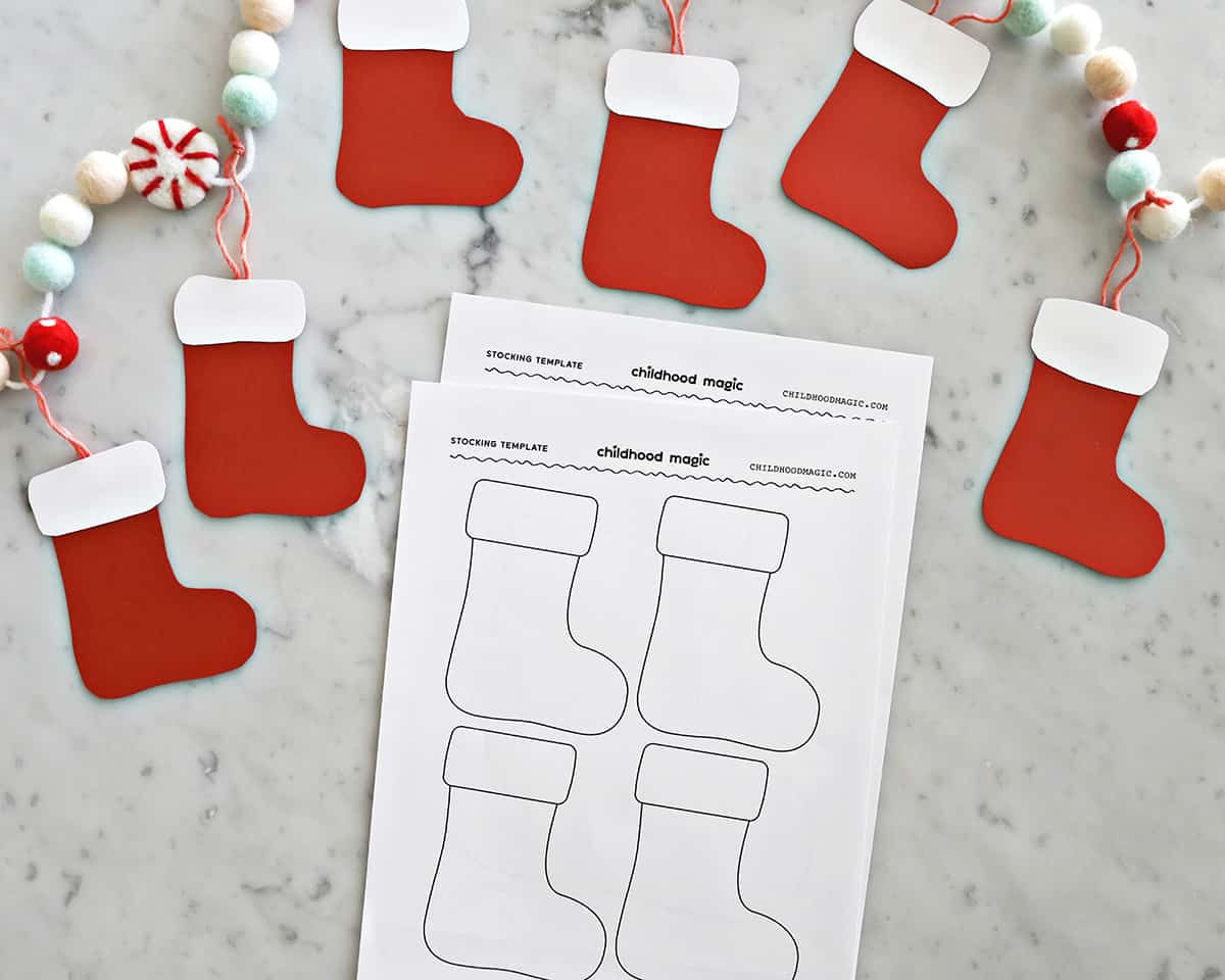 Paper stockings made with red and white construction paper added to Christmas-themed garland. 