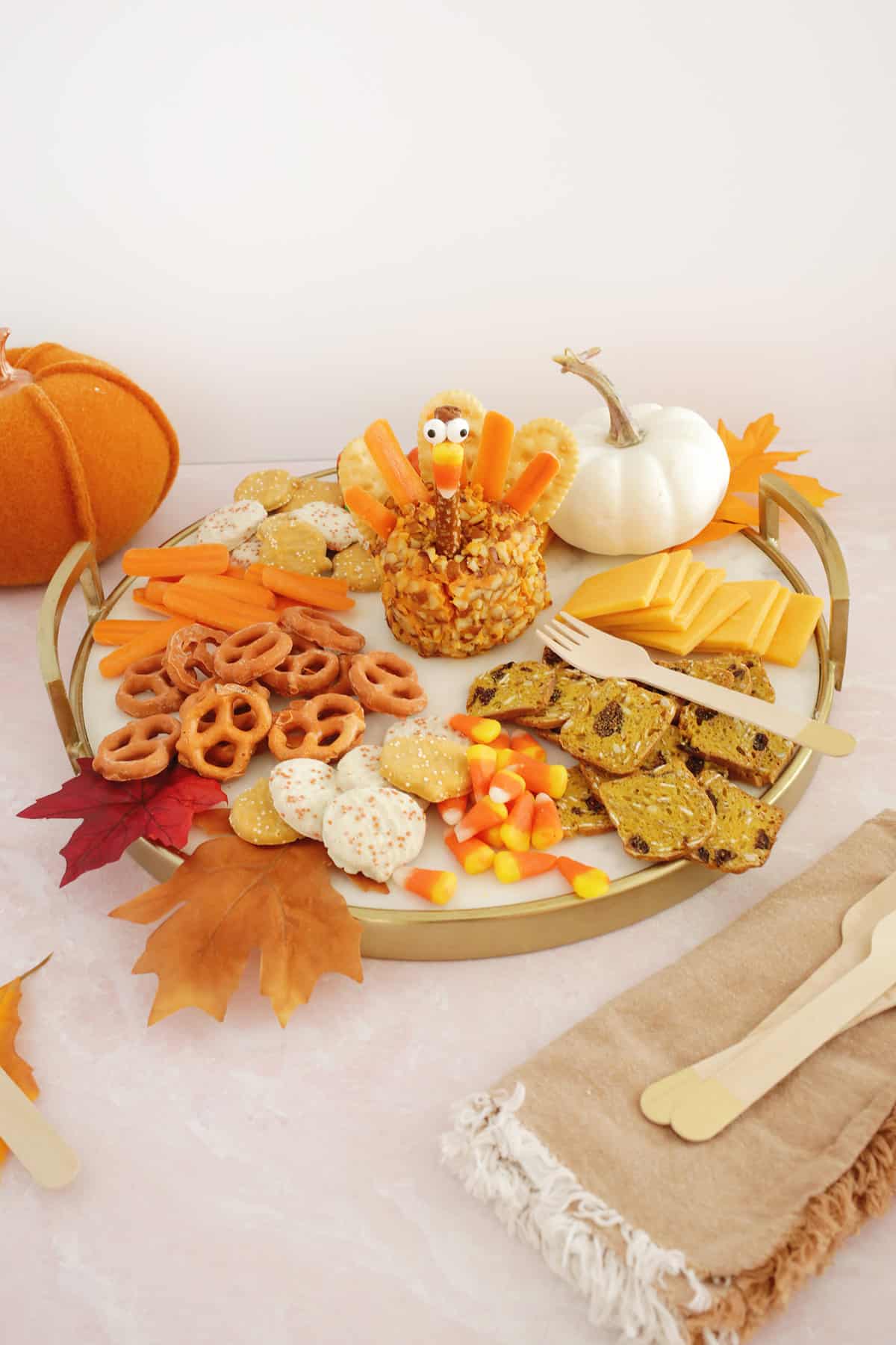 Thanksgiving charcuterie board with a turkey-shaped cheeseball in the middle