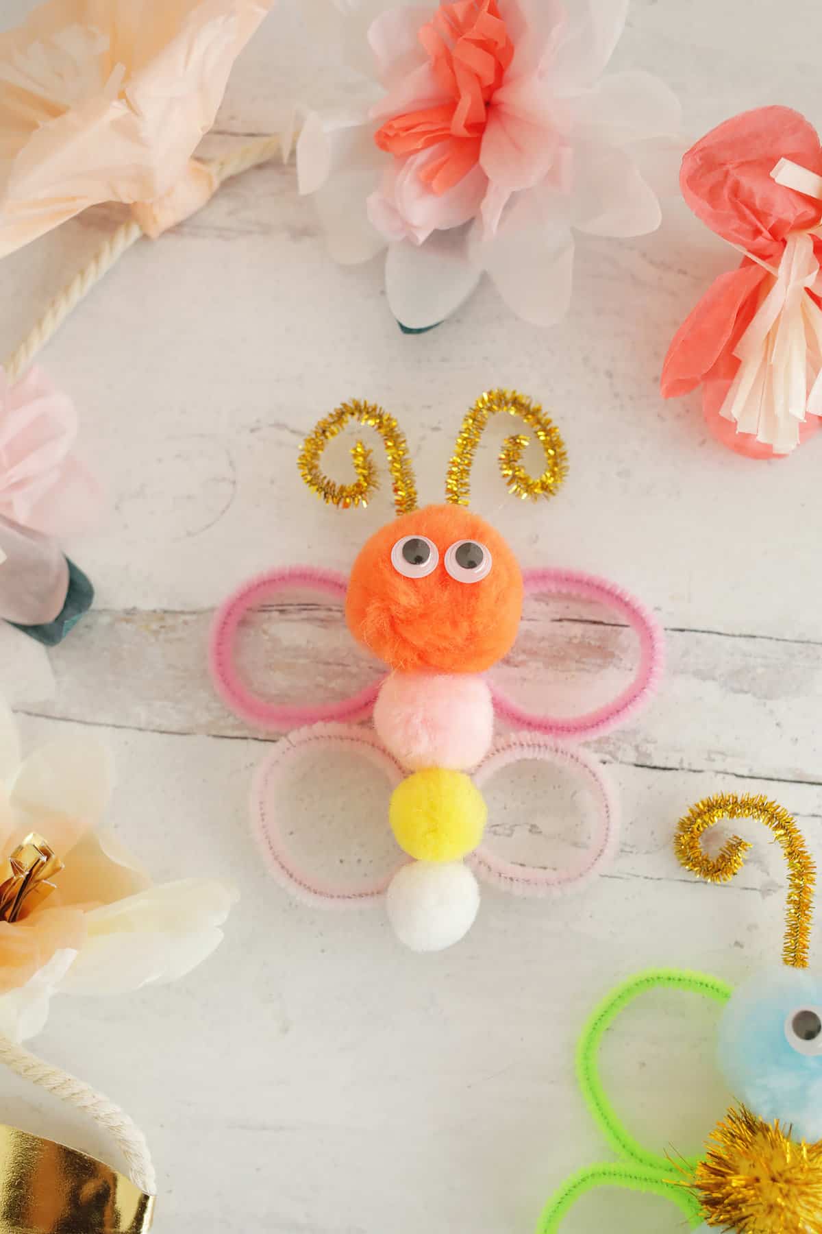 Butterfly clothespin with pom poms and pipe cleaner wings