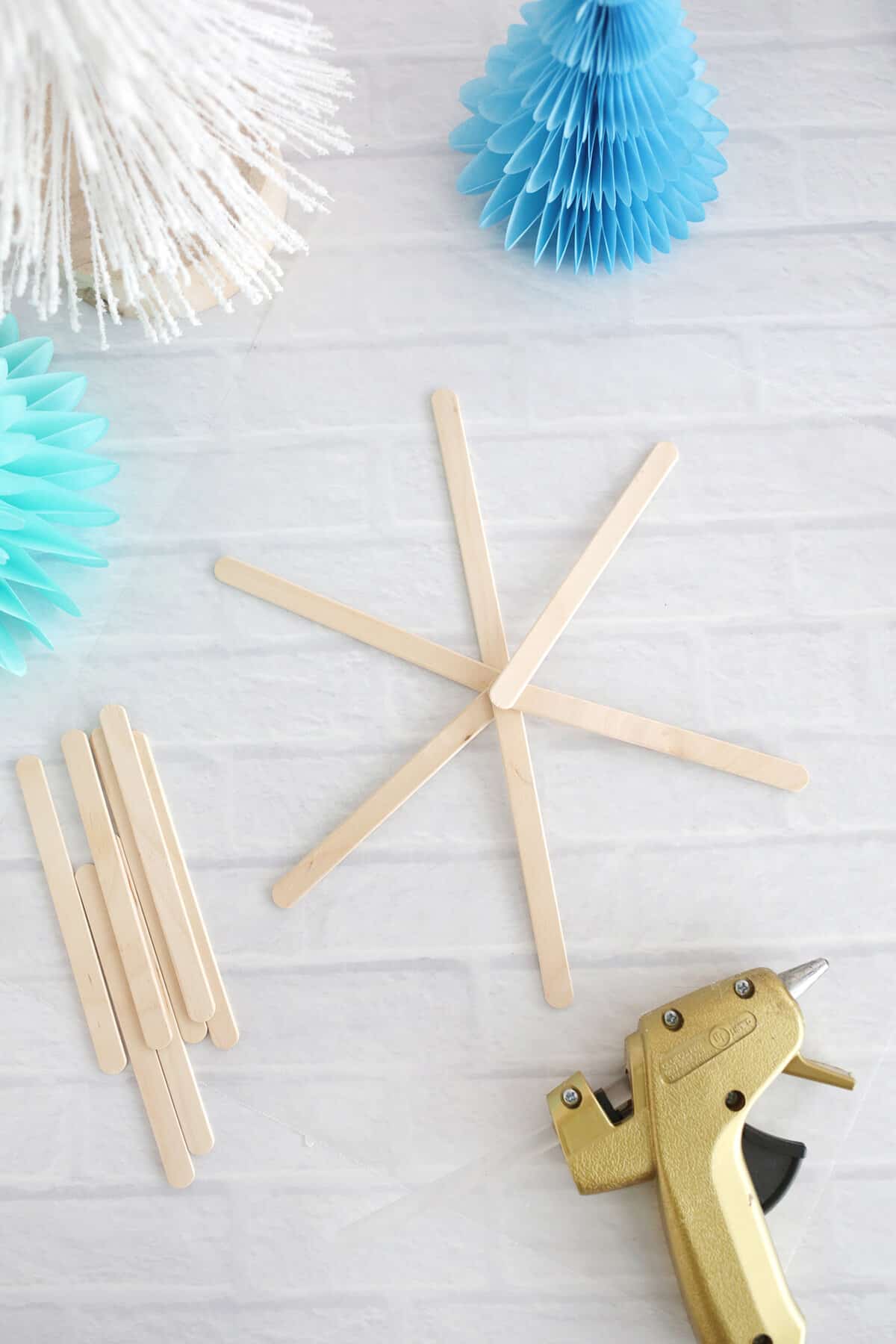 popsicle sticks being made into snowflakes