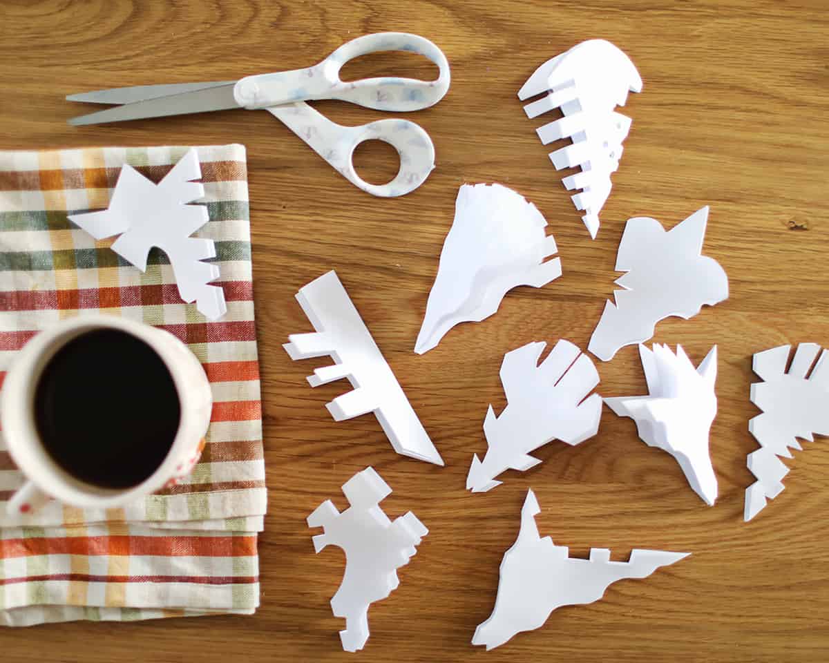 paper folded into shapes and cut into paper snowflakes. 
