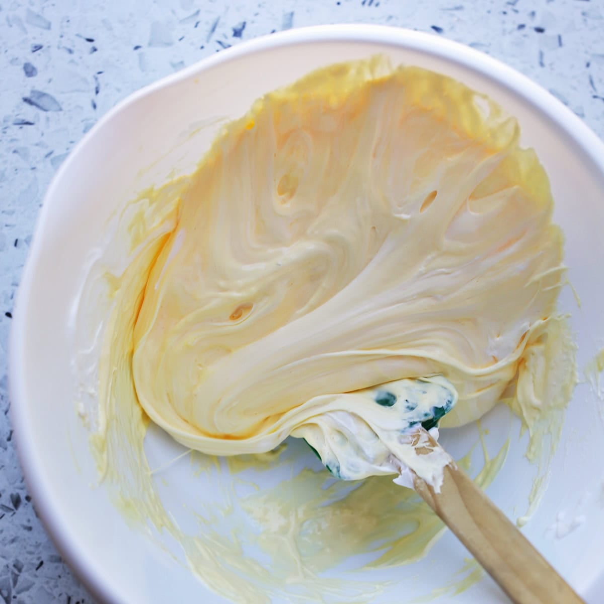 ingredients for slime being added into a bowl.