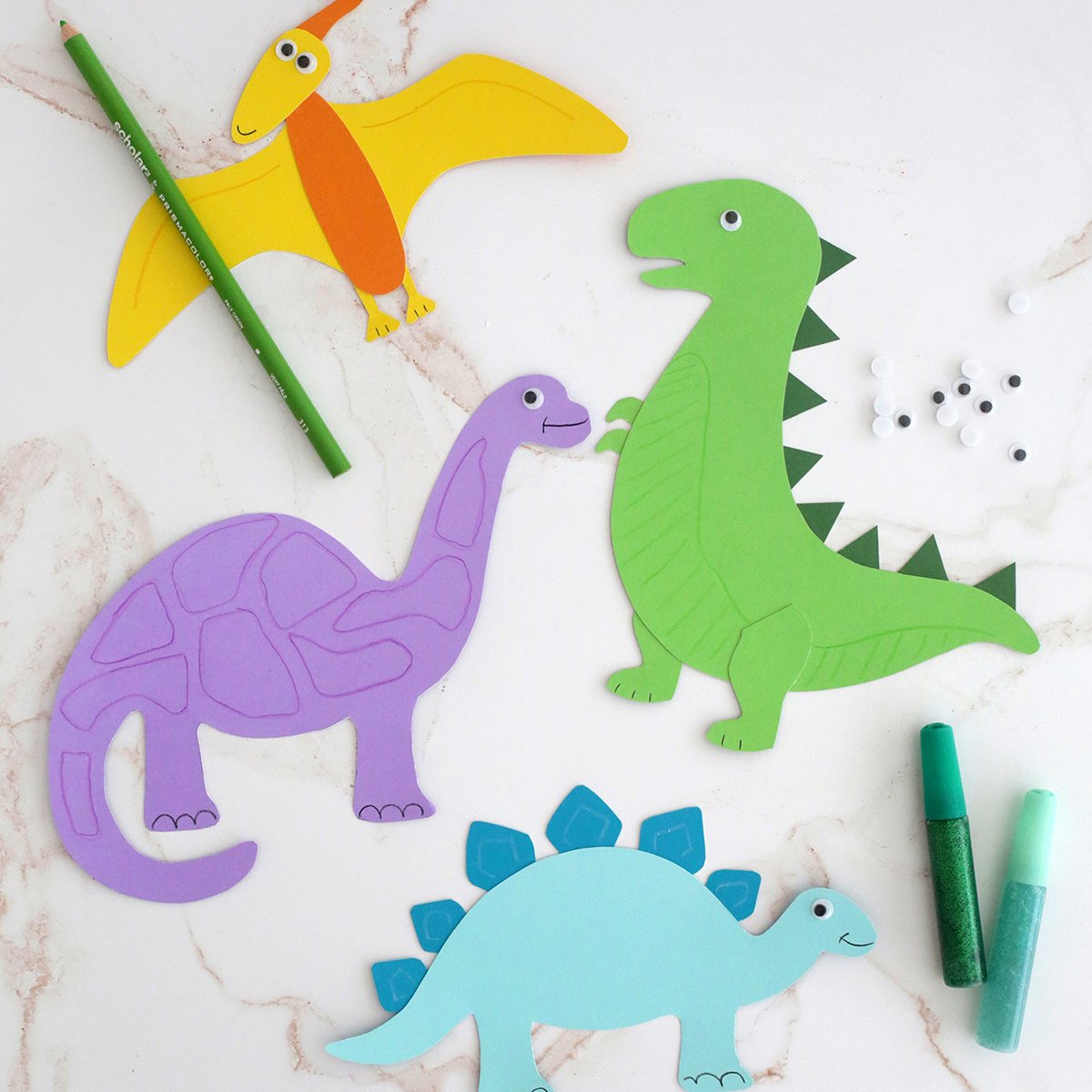 Dinosaurs cut out of colored paper and made into a kids craft. 