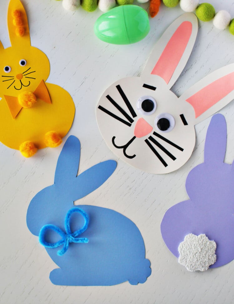 Bunny shapes cut out of cardstock and decorated with pipe cleaners, pom poms and googley eyes.