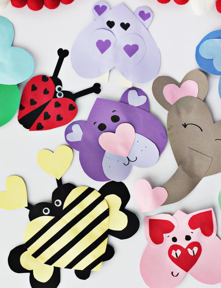 Various colors of cardstock used to make animals out of heart shapes.