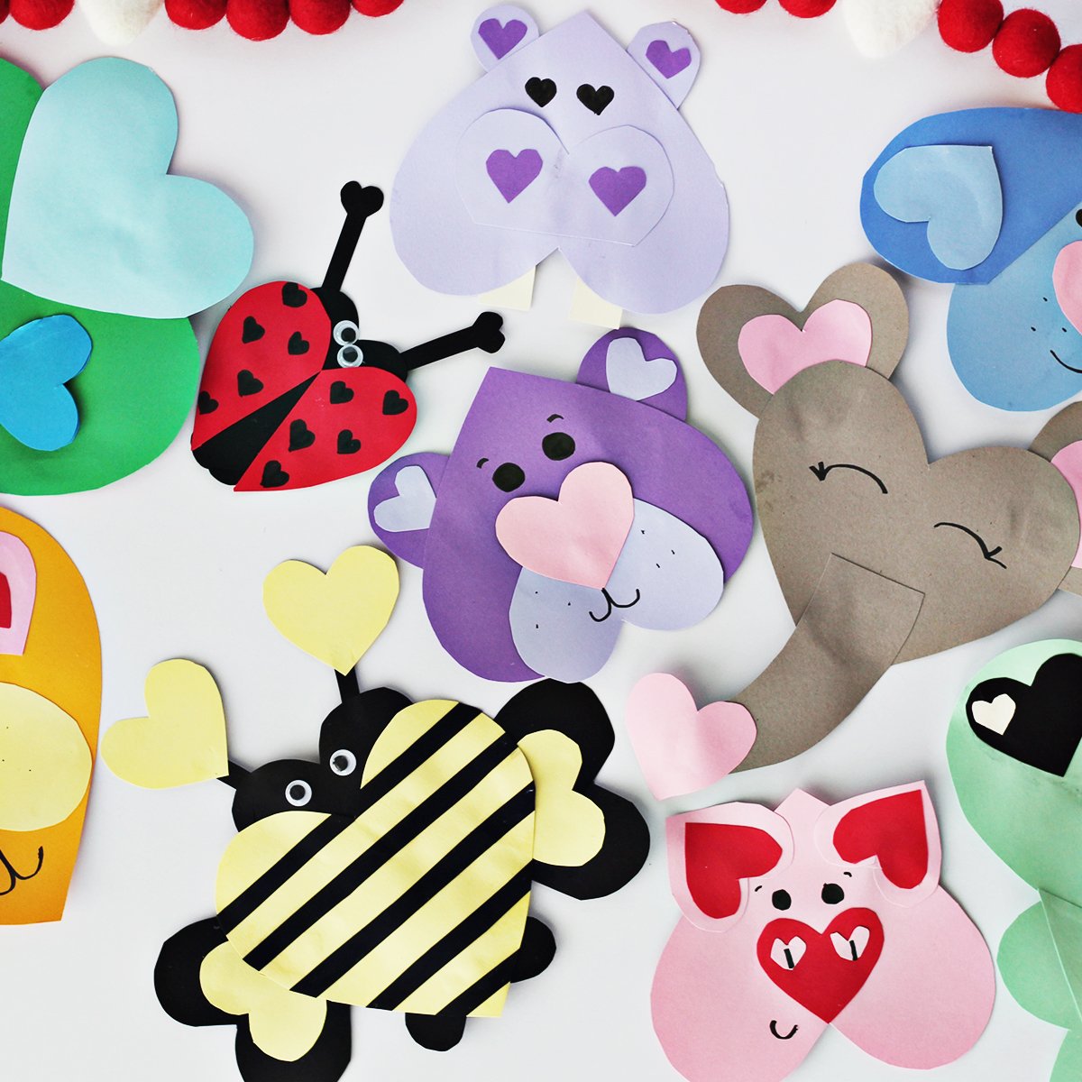 Various colors of cardstock used to make animals out of heart shapes. 