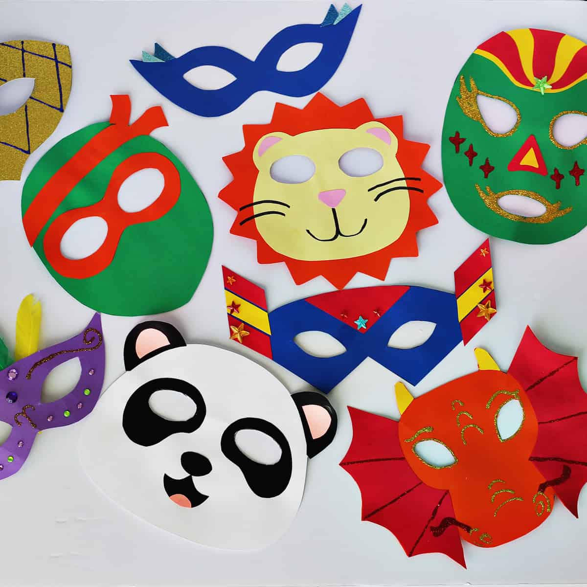 masks made out of cardstock in various colors on a white background. 
