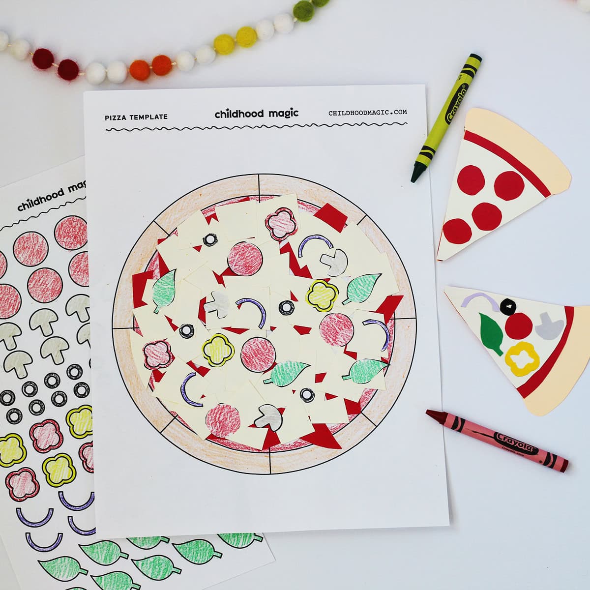Outline of a pizza on a white paper colored in with pieces of paper added to it and cut out ingredient illustrations. 