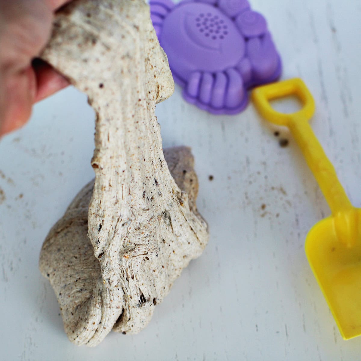 Beach slime recipe next to sand box toys.