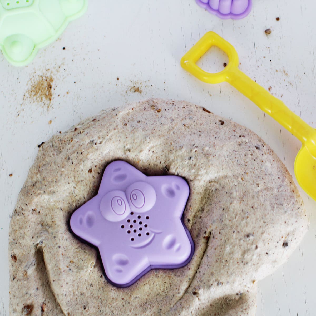 Sand slime with a starfish sand toy.