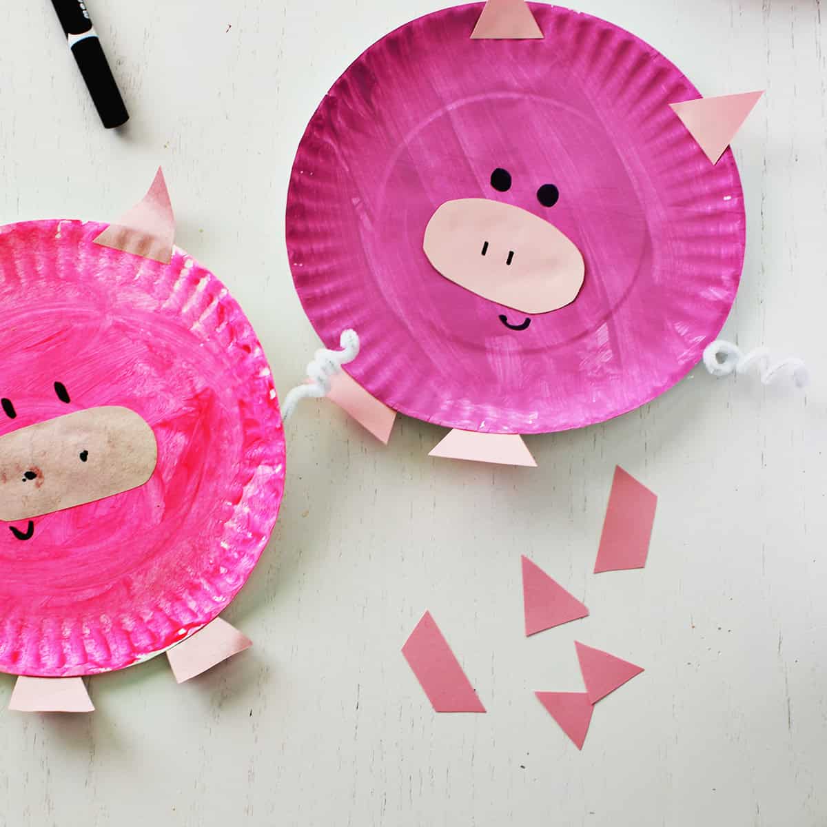 Pink paper plate painted and decorated to look like a pig.