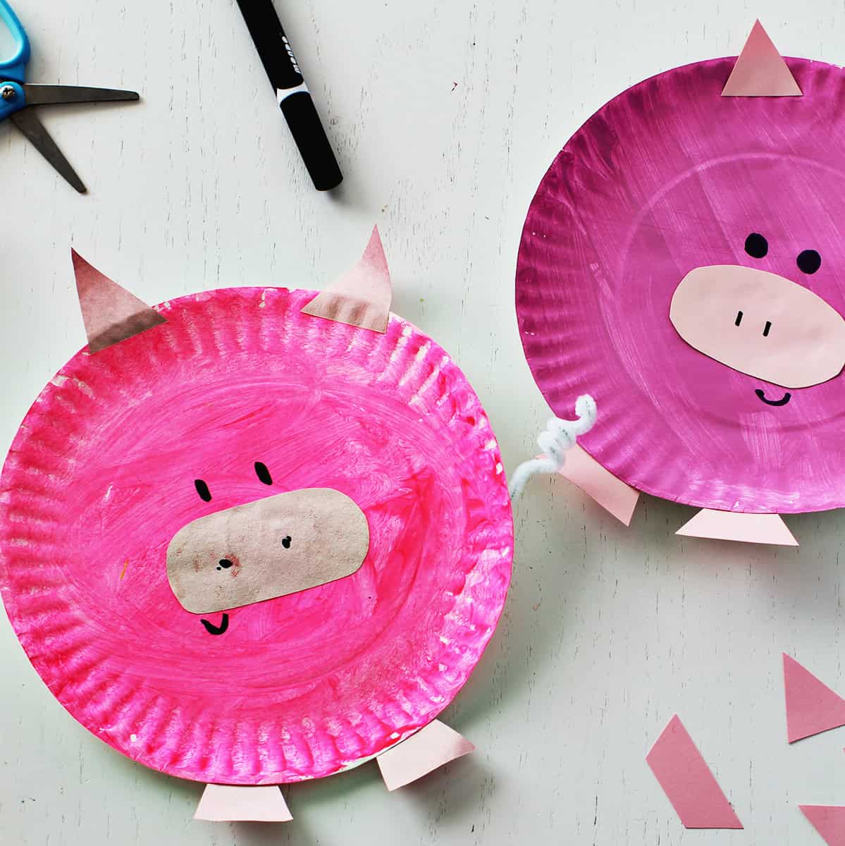 Pink paper plate painted and decorated to look like a pig.