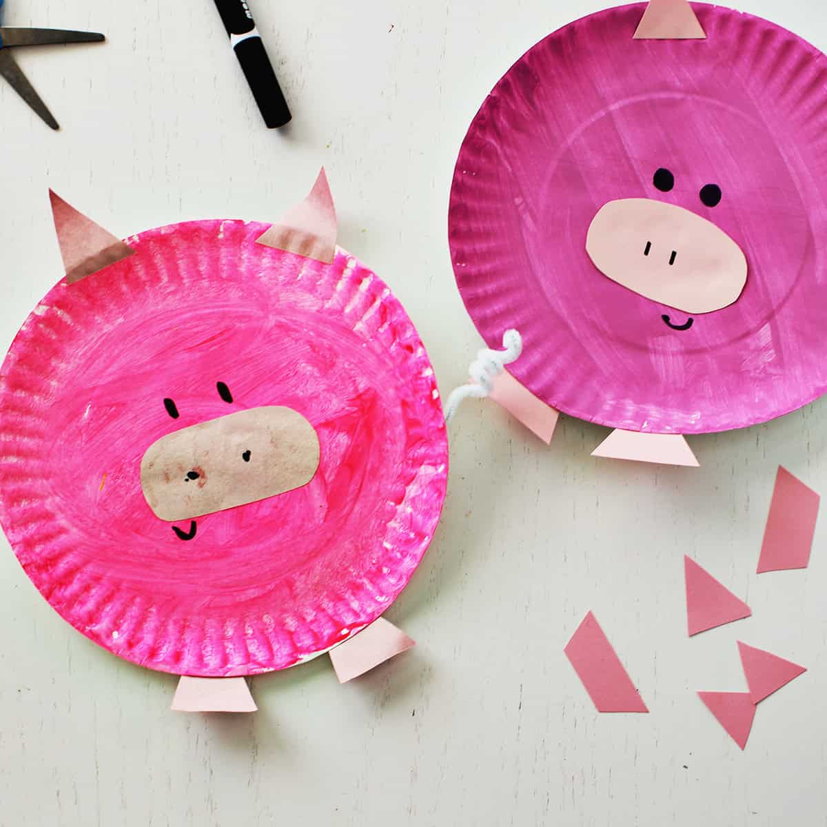 Pink paper plate painted and decorated to look like a pig.