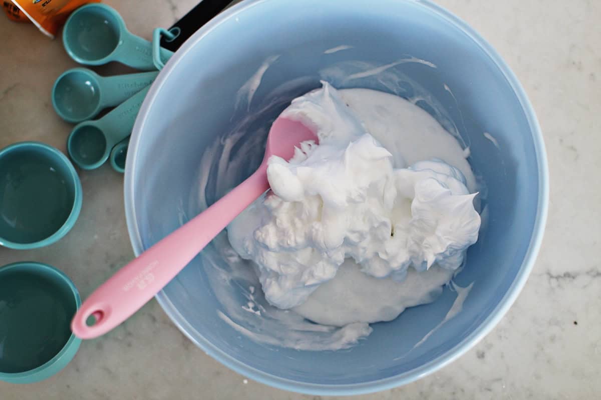 slime and shaving cream in a bowl to make fluffy slime.
