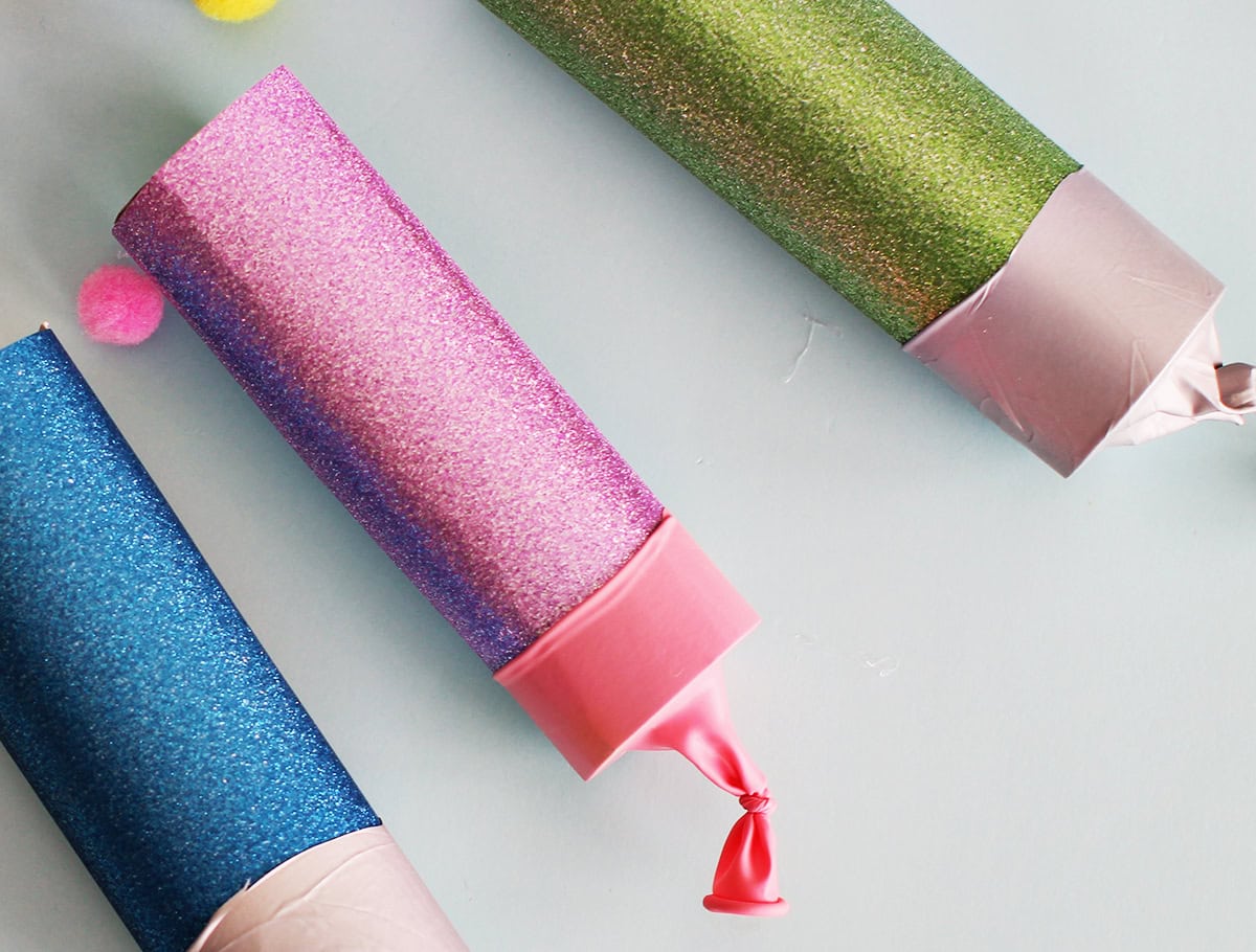 Balloon popper made from paper towel tube.