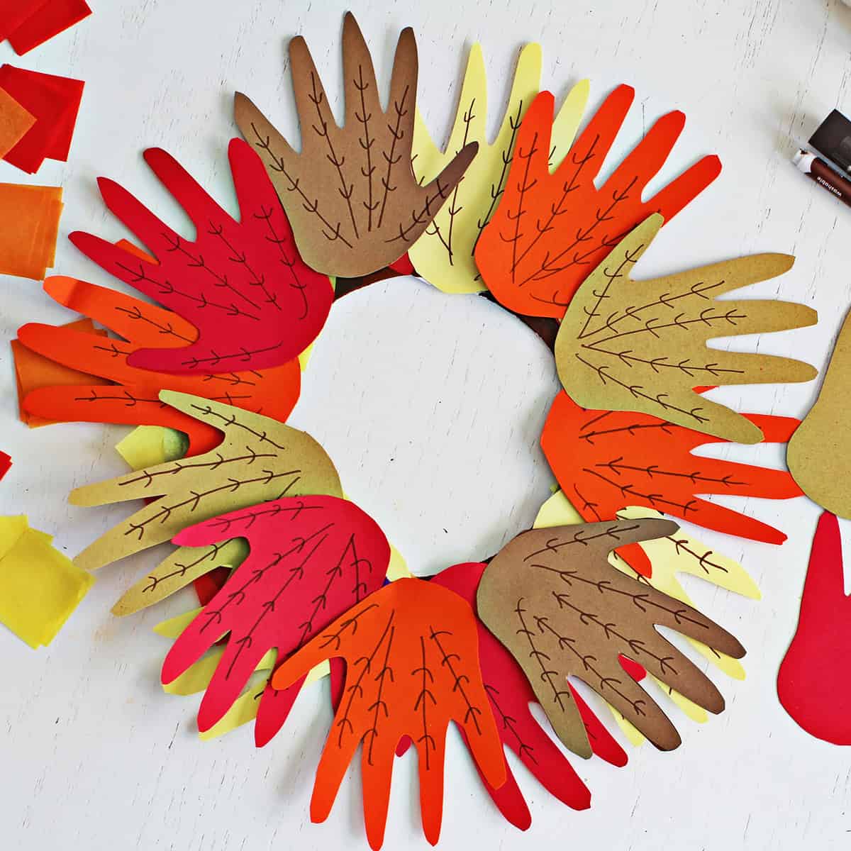 Fall handprint wreath made from a paper plate.