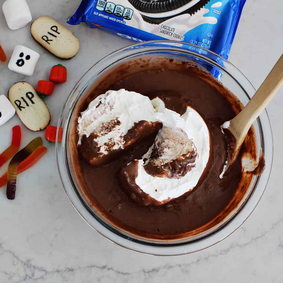 Cool whip being added to bowl of instant pudding mixture.