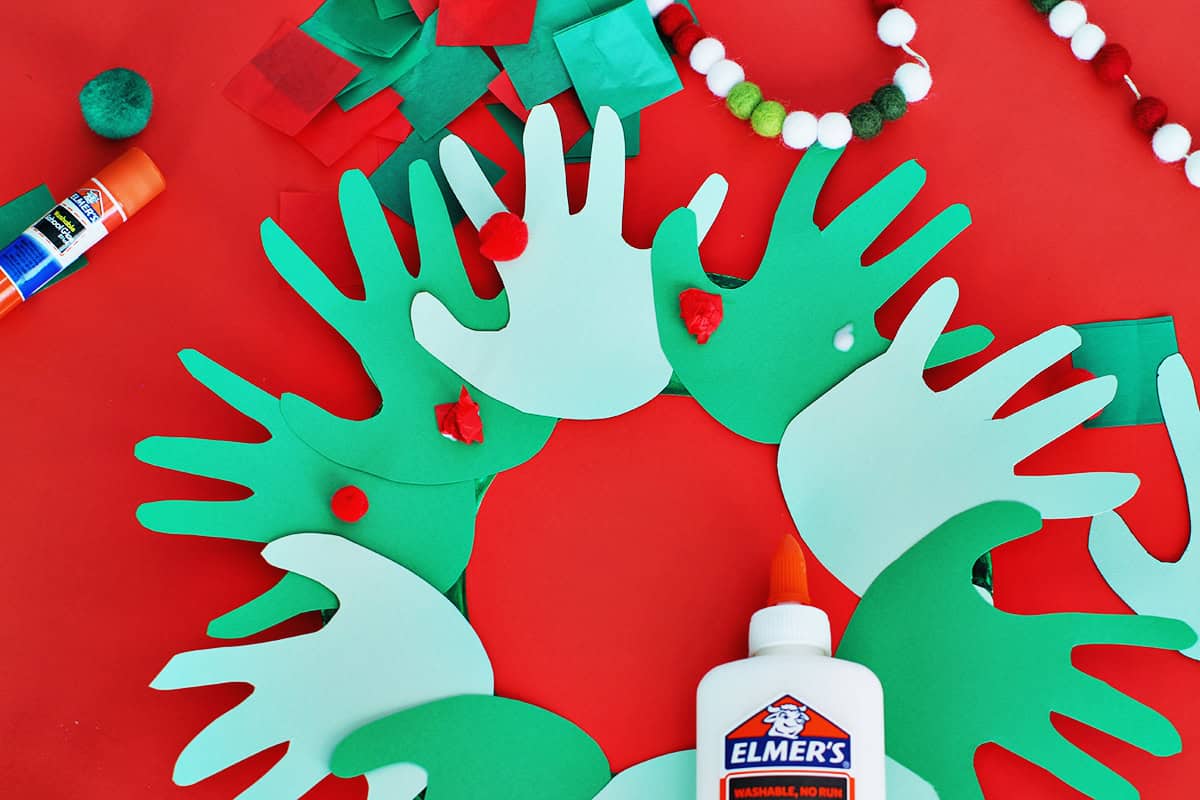 Glueing on tissue paper and poms as berries.