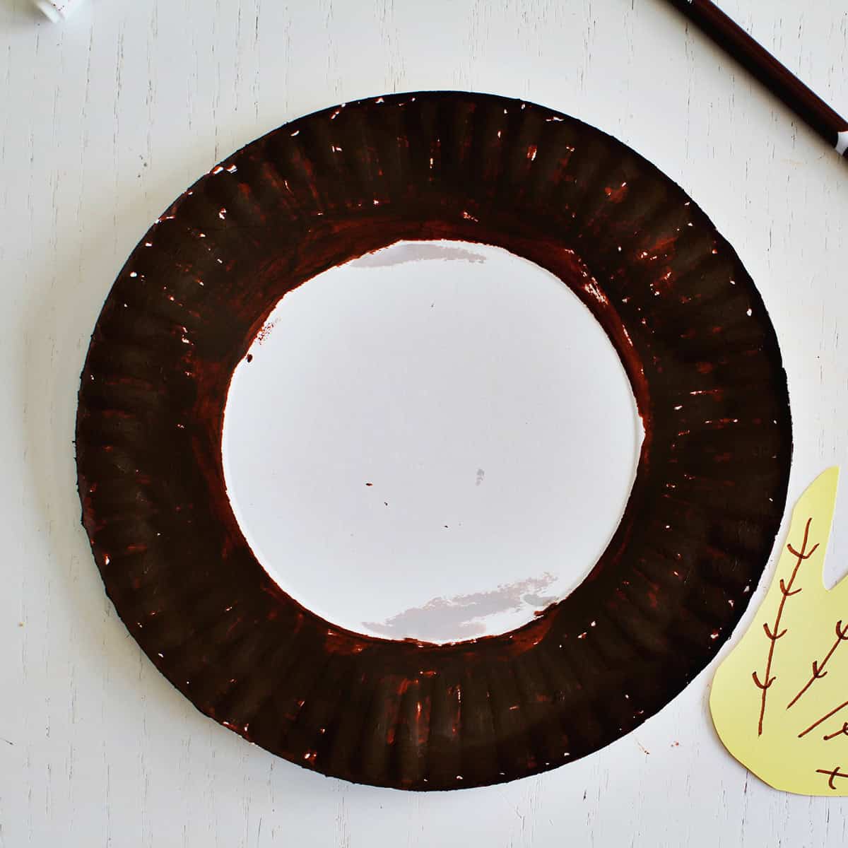 brown paper plate ring for a fall wreath kids craft.