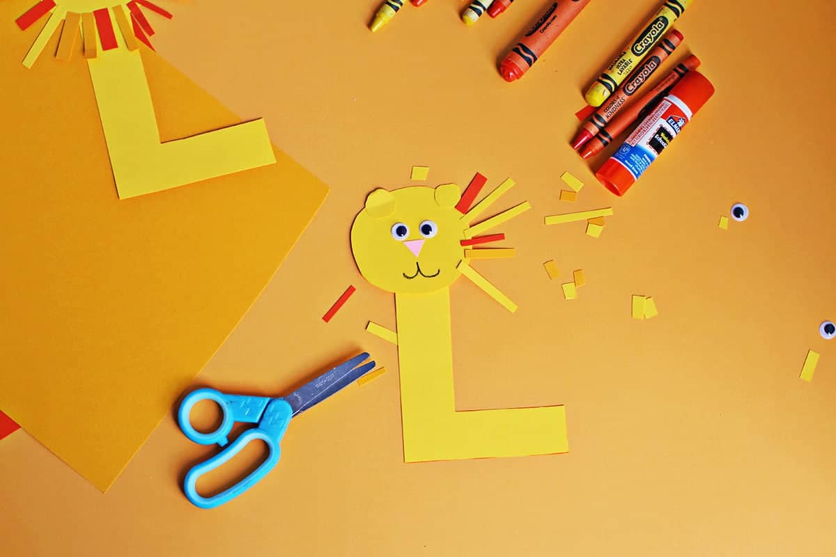 Cut out cardstrock strips being added to the cut out Lion craft.