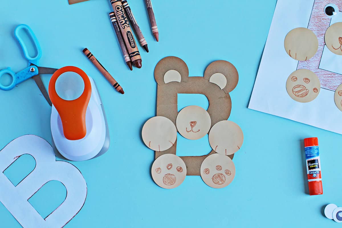Brown crayon being used to add a nose and paws to a B is for Bear craft.