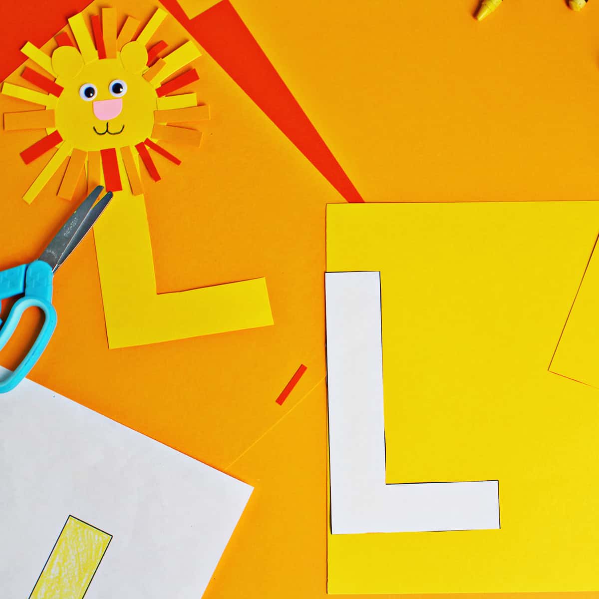 yellow cardtock being traced with a letter 'L' template and cut out.