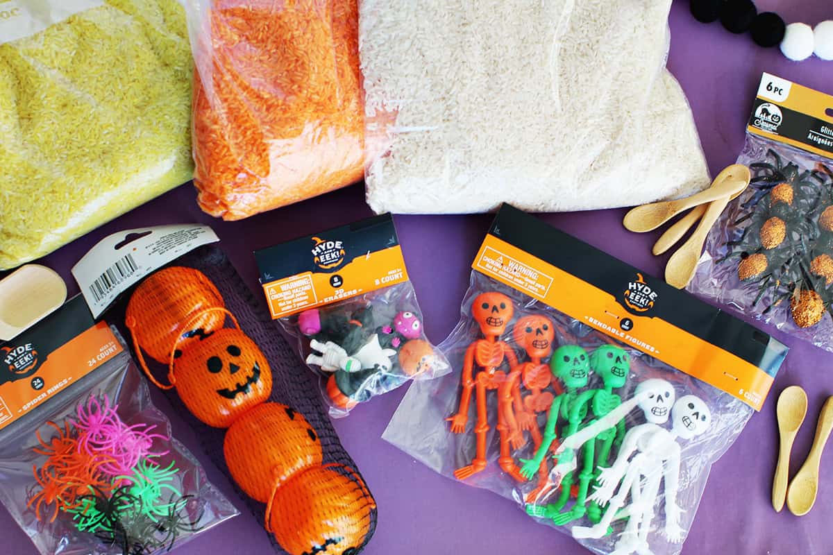 toys and dyed rice to make a Halloween sensory bin.